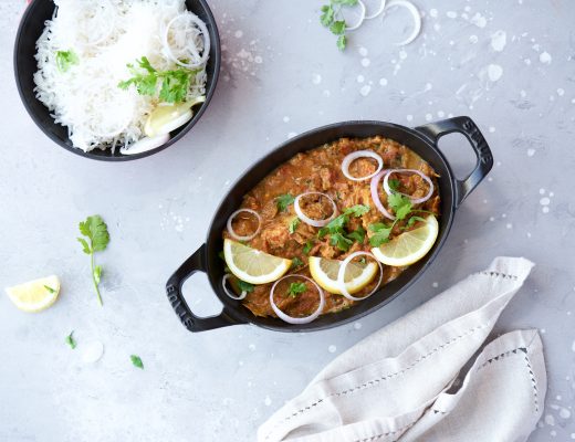 Spicy Chicken Latpata served with basmati rice and naan, garnished with fresh coriander.